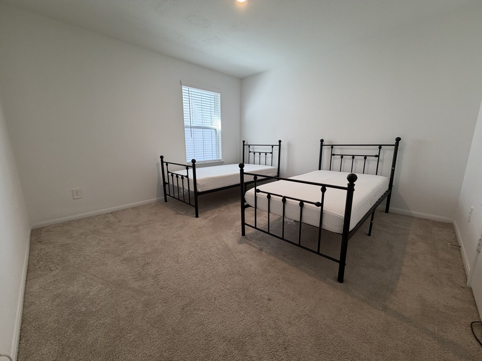 Furnished shared bedroom with twin beds